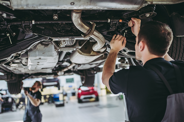 Mechanic inspecting under a car