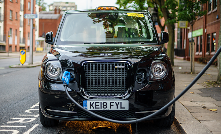 Electric taxi parked and charging